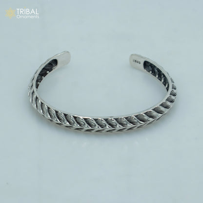 Sterling silver handmade adjustable bangle bracelet by TRIBAL ORNAMENTS, stylish unisex jewelry cuff with intricate design.