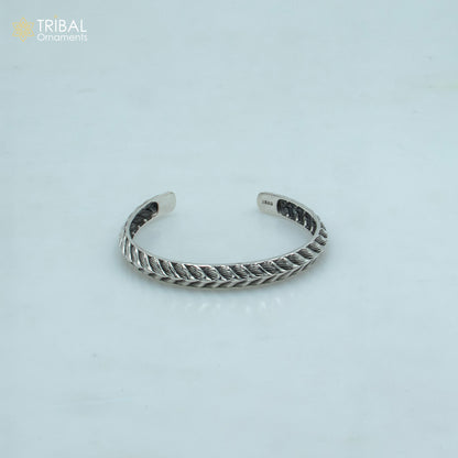 Sterling silver handmade adjustable bangle bracelet by Tribal Ornaments, unisex stylish cuff jewelry with intricate design.