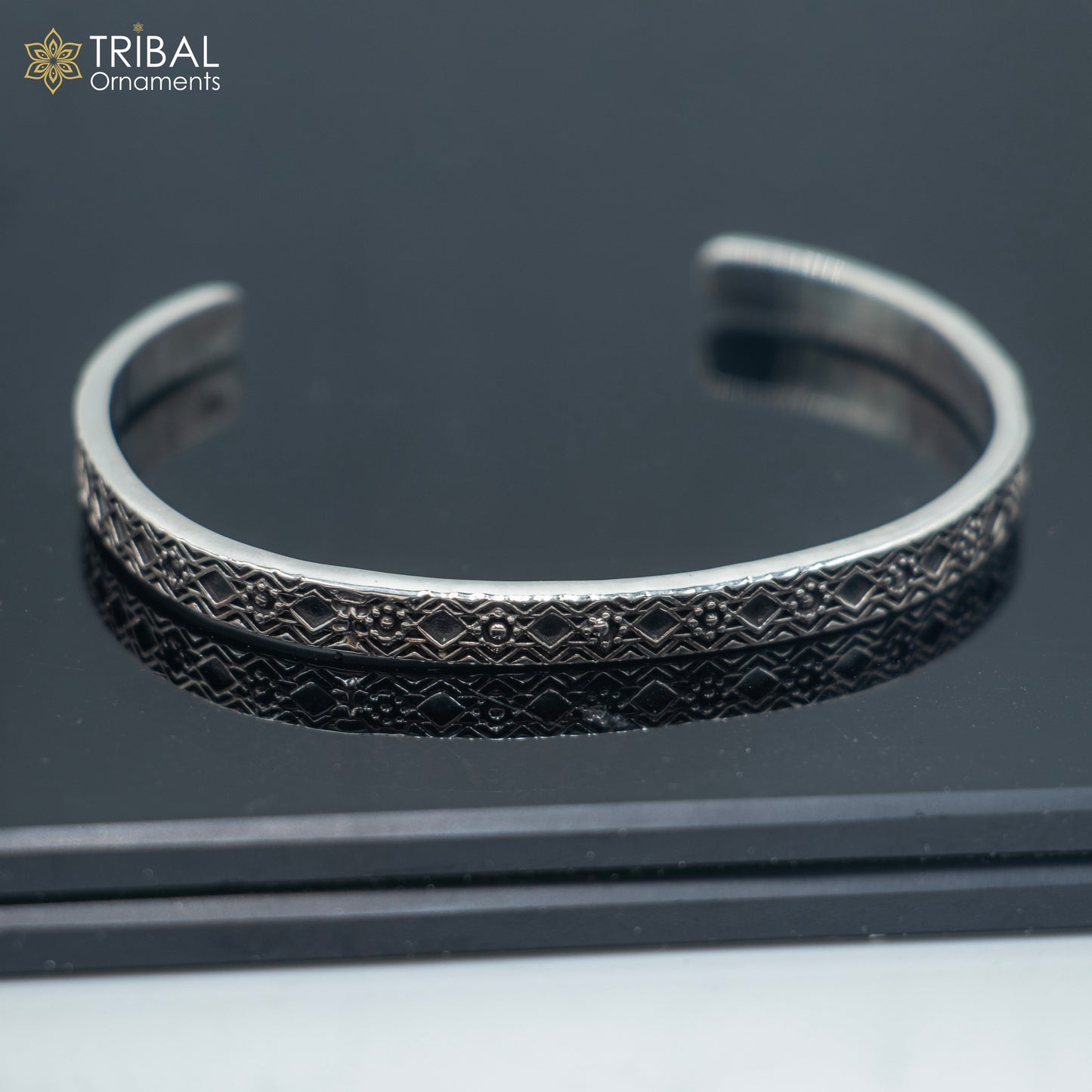 Stylish 925 sterling silver adjustable bangle cuff bracelet by TRIBAL ORNAMENTS, unisex jewelry with intricate design.