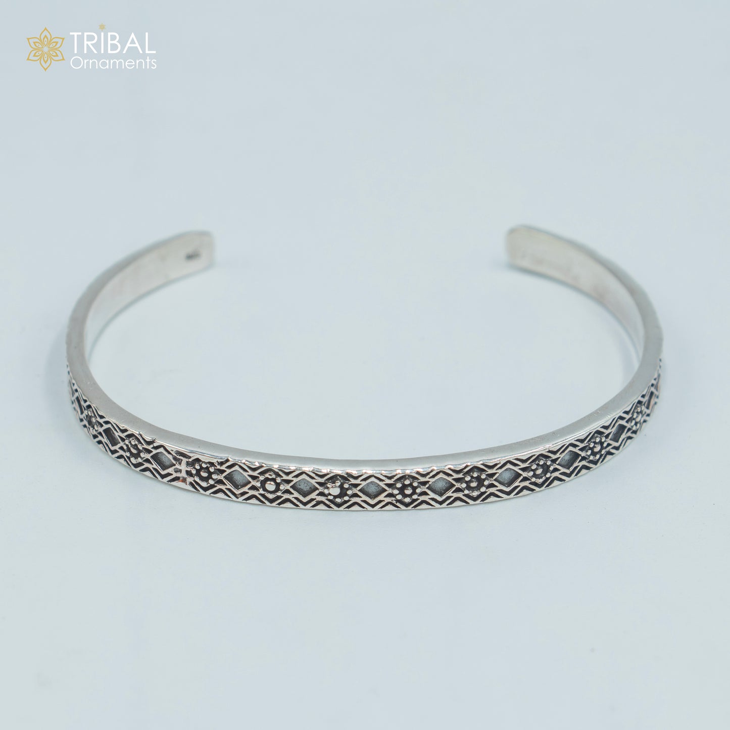 Sterling silver stylish adjustable bangle cuff bracelet by TRIBAL ORNAMENTS, unisex jewelry with intricate handmade design.