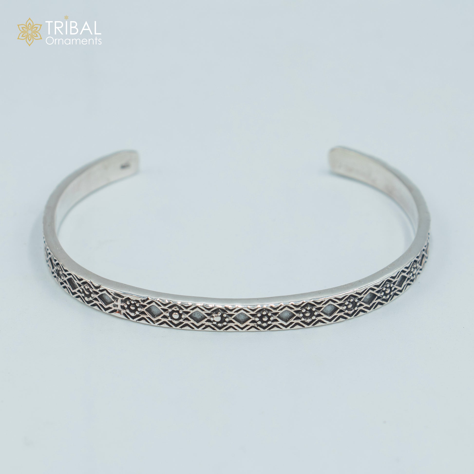 Sterling silver stylish adjustable bangle cuff bracelet by TRIBAL ORNAMENTS, unisex jewelry with intricate handmade design.