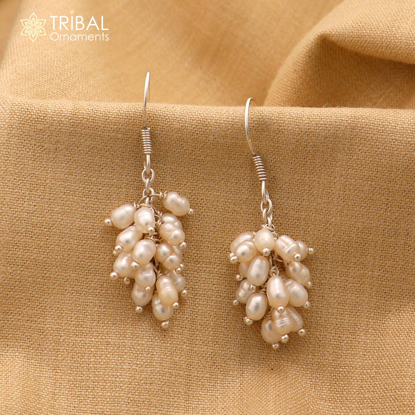 Sterling silver hoop earrings with elegant pearl accents, crafted by Tribal Ornaments, showcasing a chic and timeless jewelry design.