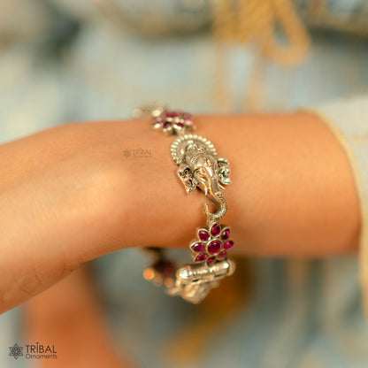 Sterling silver Ganesha design bangle bracelet with floral red stone accents, ethnic jewelry by TRIBAL ORNAMENTS.