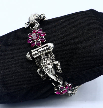 925 sterling silver Ganesha design bangle bracelet with floral red stone accents, ethnic jewelry by TRIBAL ORNAMENTS.