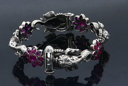 925 sterling silver Ganesha design bangle bracelet with floral red stone accents, ethnic jewelry by TRIBAL ORNAMENTS.