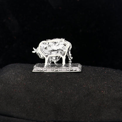 925 sterling silver Kamdhenu cow figurine by TRIBAL ORNAMENTS, symbol of wealth and prosperity, detailed deity's cow sculpture.