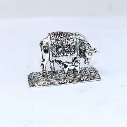 925 sterling silver Kamdhenu cow figurine by TRIBAL ORNAMENTS, depicting a deity’s cow for wealth and prosperity worship.