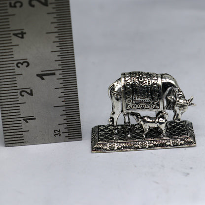925 sterling silver Kamdhenu cow figurine by TRIBAL ORNAMENTS, a deity's wishing cow symbolizing wealth and prosperity.