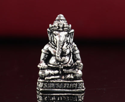 Small handcrafted 925 silver Lord Ganesh idol statue, detailed sculpture for Diwali puja and spiritual decoration.
