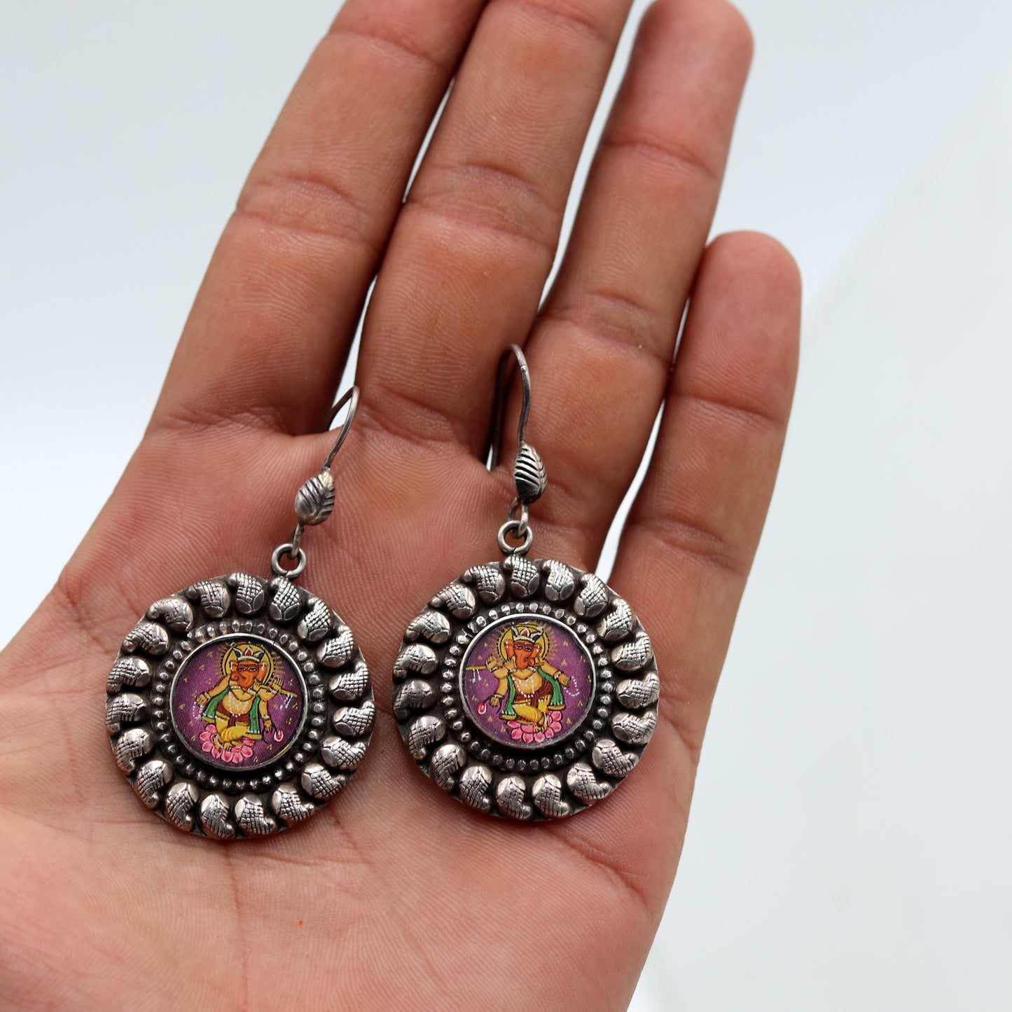 Sterling silver Lord Ganesha miniature painting dangle earrings by Tribal Ornaments featuring detailed Ganesha artwork.