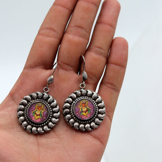 Sterling silver Lord Ganesha miniature painting dangle earrings by Tribal Ornaments featuring detailed Ganesha artwork.