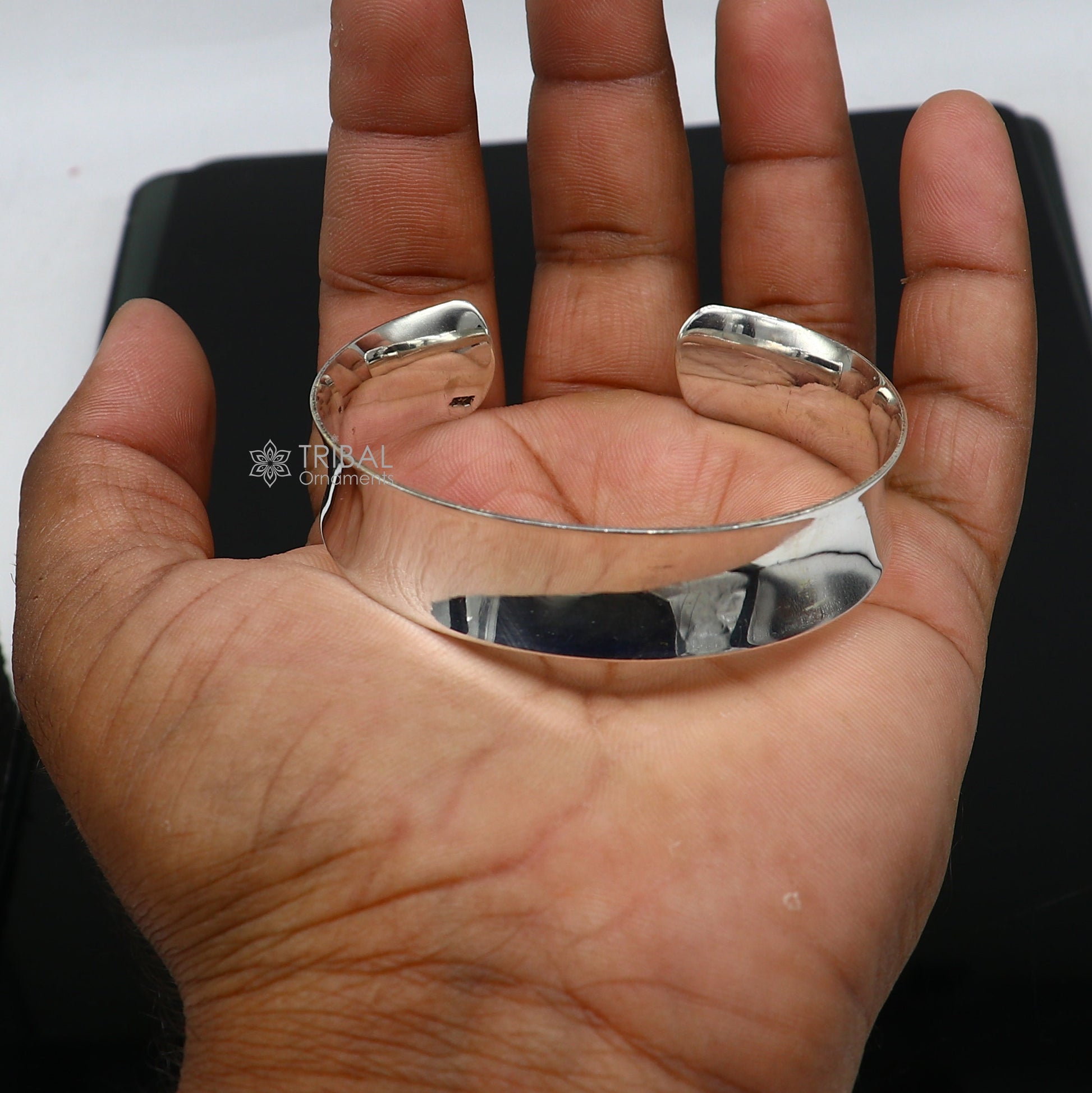 Sterling silver bangle bracelet with a shiny, plain design by TRIBAL ORNAMENTS, stylish cuff jewelry for gifting or everyday wear.