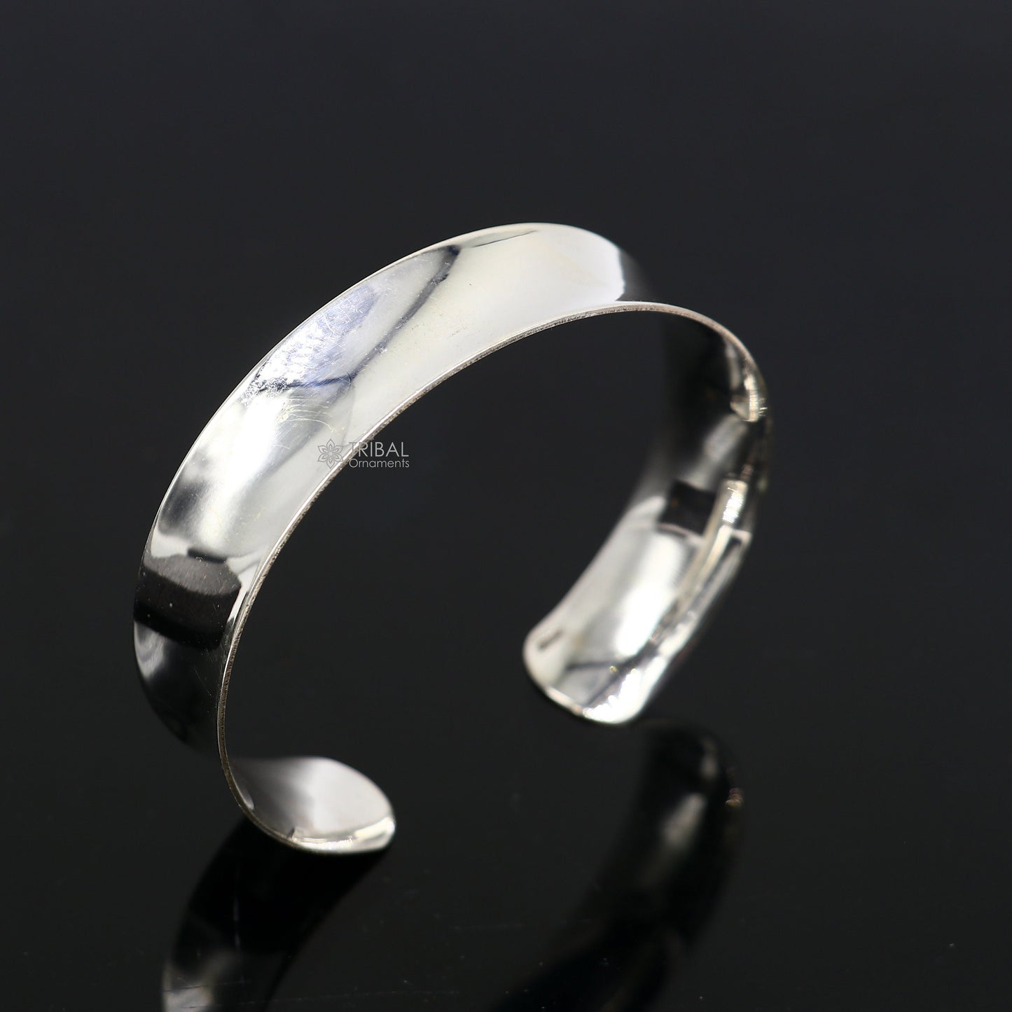 Sterling silver bangle bracelet with a shiny, plain design, stylish cuff style by TRIBAL ORNAMENTS for elegant gifting.