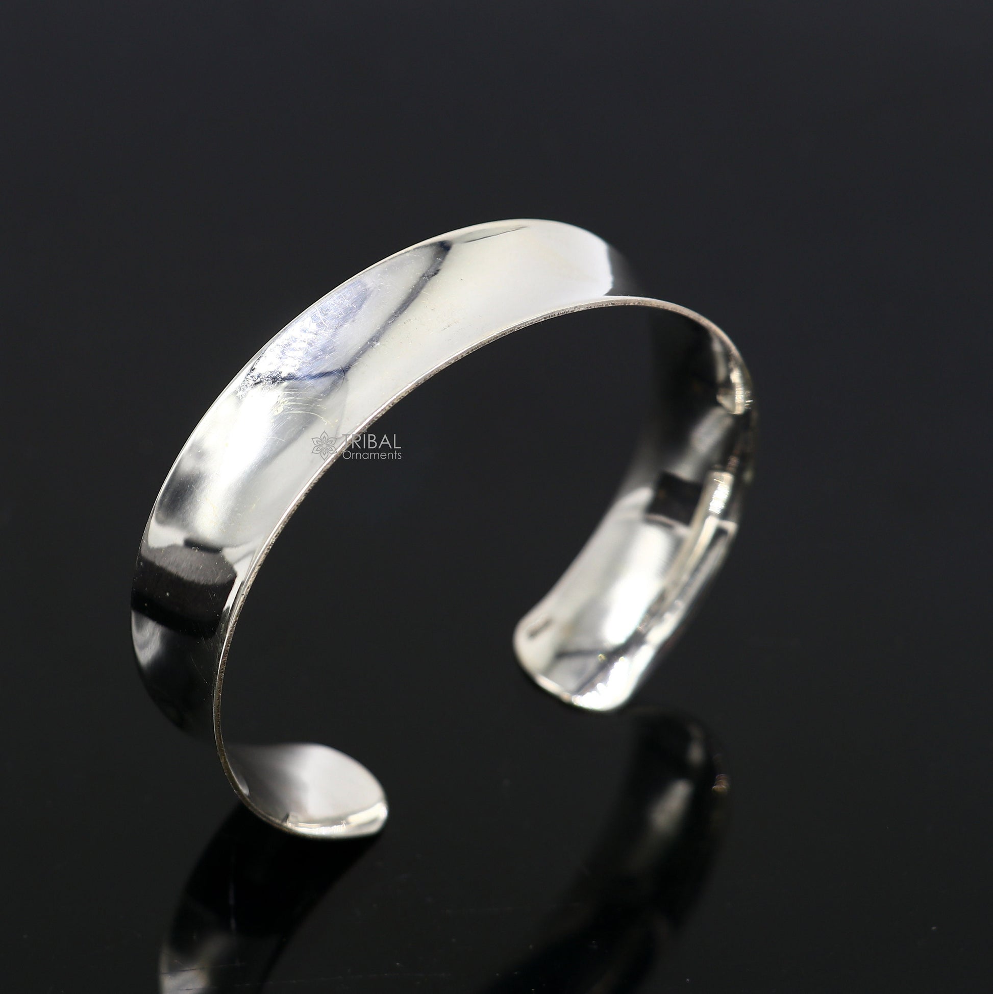 Sterling silver bangle bracelet with a shiny, plain design, stylish cuff style by TRIBAL ORNAMENTS for elegant gifting.