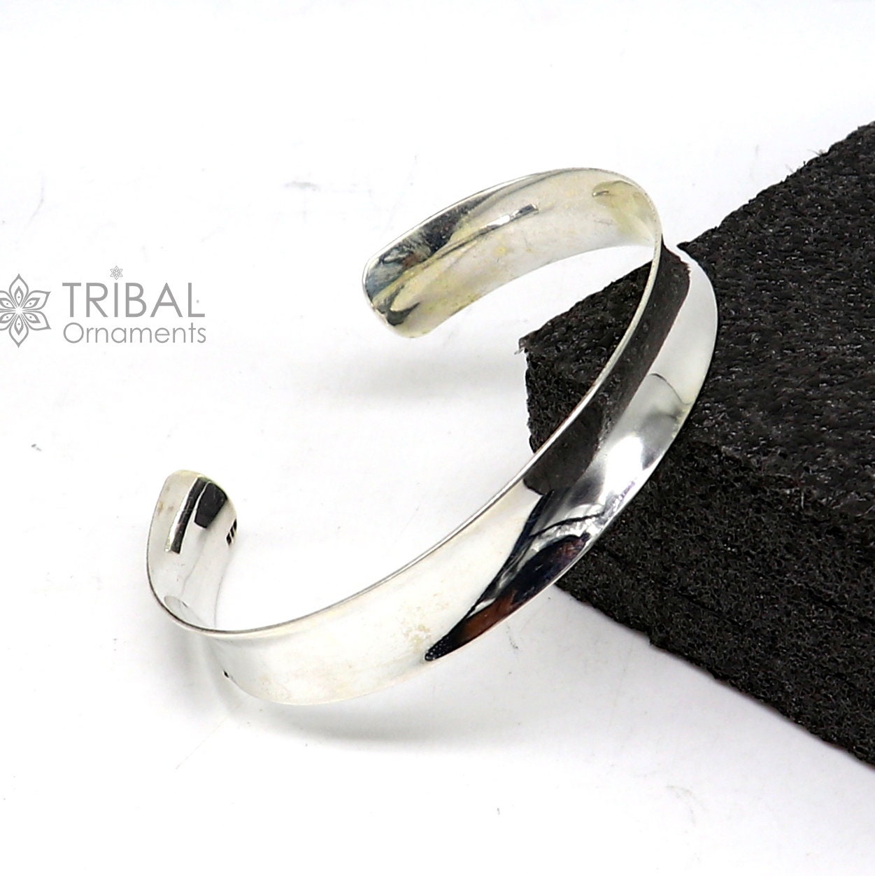 Sterling silver bangle bracelet with a shiny, plain design from TRIBAL ORNAMENTS, featuring a stylish cuff kada style for gifting.