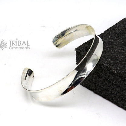Sterling silver bangle bracelet with a shiny, plain design from TRIBAL ORNAMENTS, featuring a stylish cuff kada style for gifting.