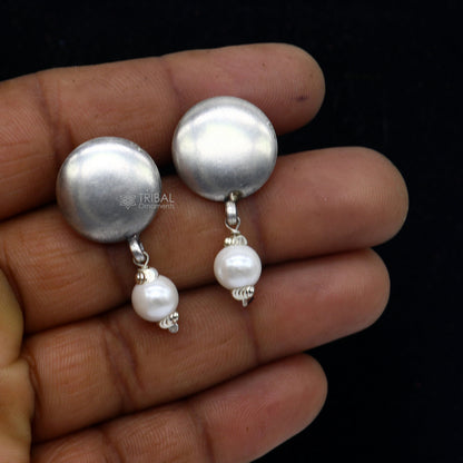 Sterling silver handmade round stud earrings with tribal design from Rajasthan, India, featuring a plain style and intricate craftsmanship.
