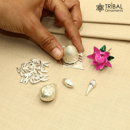 925 sterling silver Pooja accessories including Supari, Paan leaves, rice, cloves, coconut, cardamom, and flower for worship.