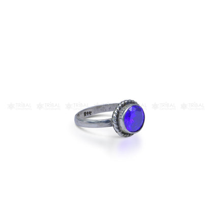 Sterling silver purple stone ring from TRIBAL ORNAMENTS featuring a vibrant purple gemstone and intricate silver band design.