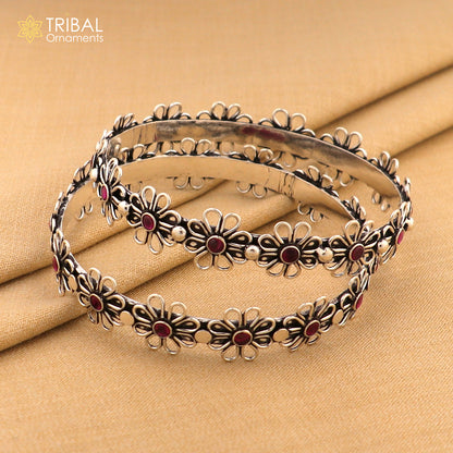 Sterling silver bangle bracelet with red stone flower design, handmade jewelry by TRIBAL ORNAMENTS.