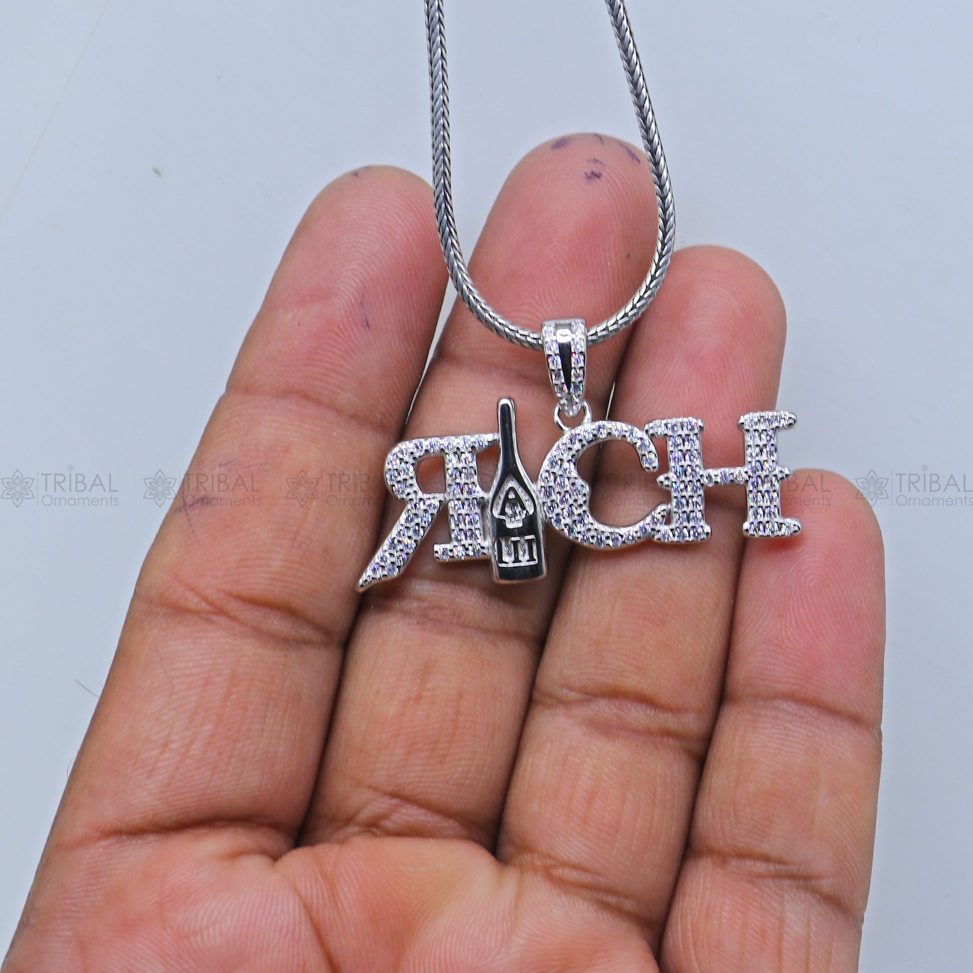 925 Sterling silver men's pendant featuring intricate tribal design from TRIBAL ORNAMENTS, shown with detailed craftsmanship.