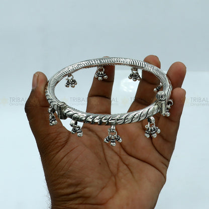 925 sterling silver ankle kada with hanging bells, stylish tribal design, showcasing intricate craftsmanship and elegant foot jewelry.