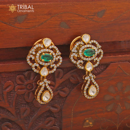 Sterling silver tribal jewelry set with white kundan stone and polki charms, featuring an intricate necklace and matching earrings.