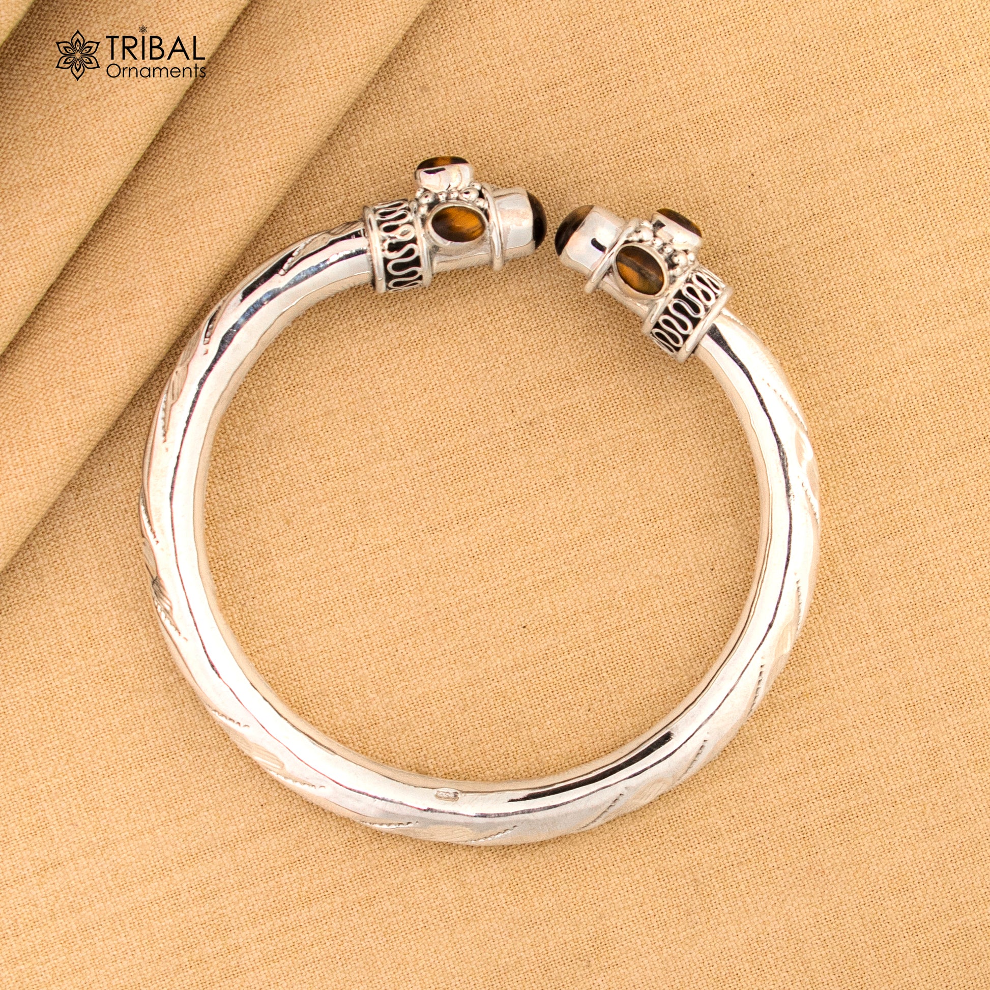 Unisex 925 sterling silver bangle bracelet with tiger eye stone, featuring a sleek design and customizable jewelry by Tribal Ornaments.