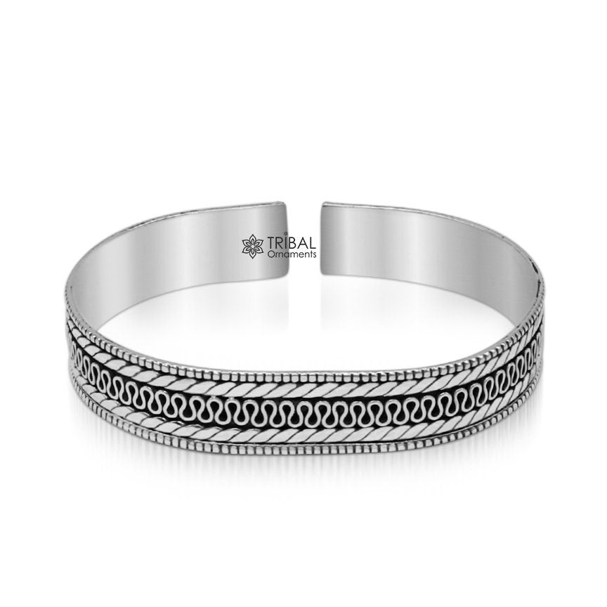 Sterling silver vintage handmade bangle cuff bracelet with intricate tribal design by TRIBAL ORNAMENTS, showcasing detailed craftsmanship.