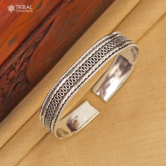 Sterling silver vintage-style handmade tribal bangle bracelet with intricate design and traditional craftsmanship.