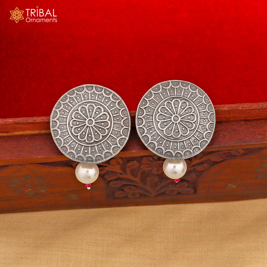 Vintage-style round sterling silver earring by TRIBAL ORNAMENTS featuring traditional design and intricate detailing.