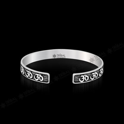 Sterling silver 'AUM' mantra adjustable bangle cuff by Tribal Ornaments, unisex divine jewelry with handcrafted design.
