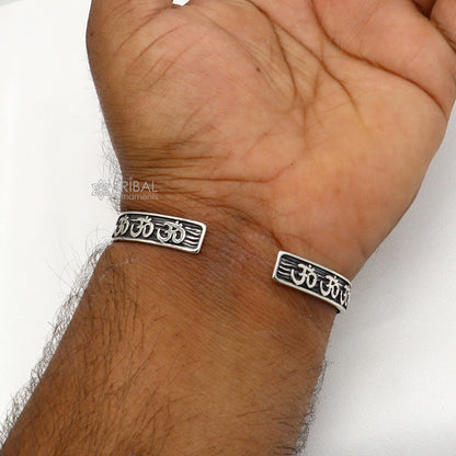 Unisex 925 sterling silver 'AUM' mantra adjustable cuff bracelet with intricate handcrafted design by TRIBAL ORNAMENTS.