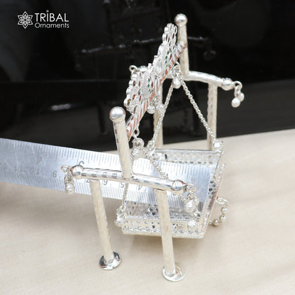 Sterling silver peacock design Bal Gopala jhula swing featuring child Krishna, detailed tribal ornament art for divine decoration.