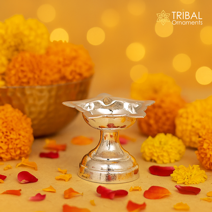 Handmade 999 pure silver oil lamp by TRIBAL ORNAMENTS, elegant silver diya for home temple and puja rituals.