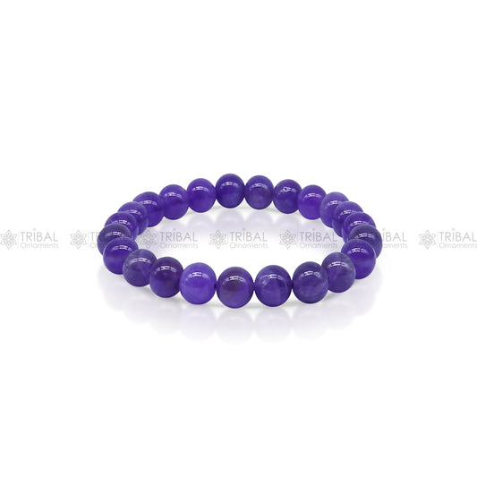 Amethyst bracelet by Tribal Ornaments featuring purple beads, designed to promote calm and clarity, displayed on a neutral background.