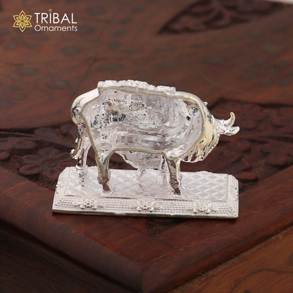 Silver Kamdhenu cow with calf sculpture featuring vintage Nakshi work design, depicting a divine wishing cow, crafted by Tribal Ornaments.