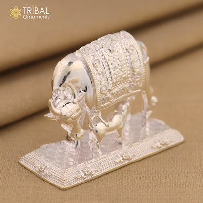 Silver divine cow with calf ornament featuring vintage Nakshi work design, representing Kamdhenu deity and wishing cow art.
