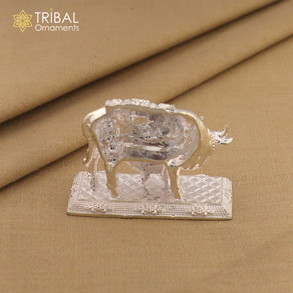 Vintage sterling silver Kamdhenu cow with calf, intricate Nakshi work, detailed deity-inspired design, traditional tribal ornament art.