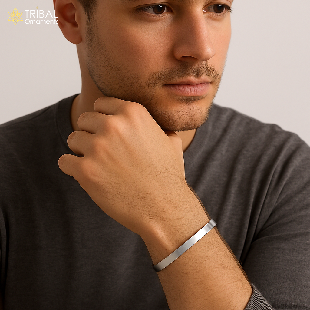 Obliq style shiny 925 silver bangle cuff, men's jewelry by TRIBAL ORNAMENTS, featuring a sleek, plain silver design.