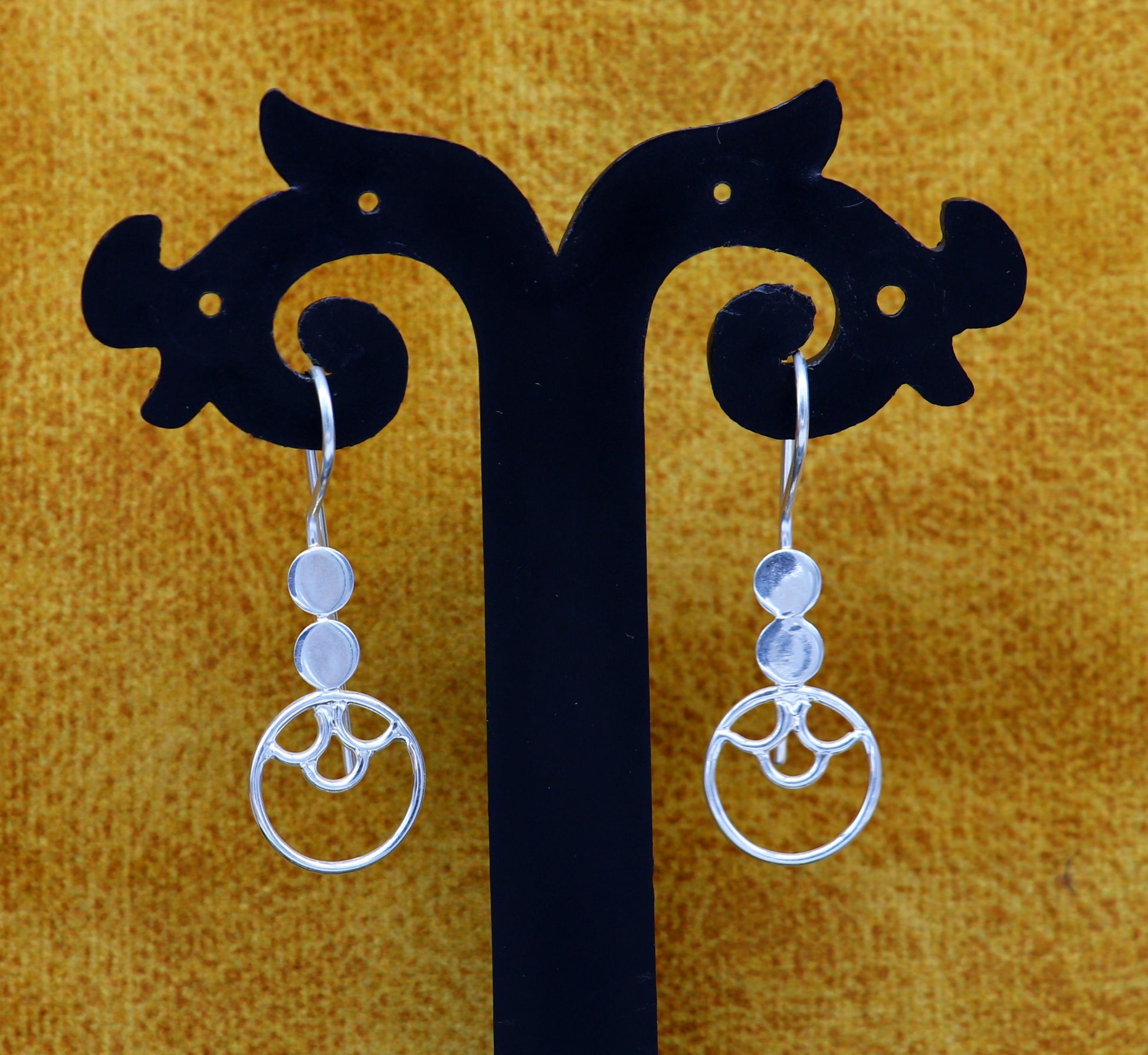Handmade sterling silver hoop earring by TRIBAL ORNAMENTS featuring a circle shape, stamped 925, fashionable jewelry for women.