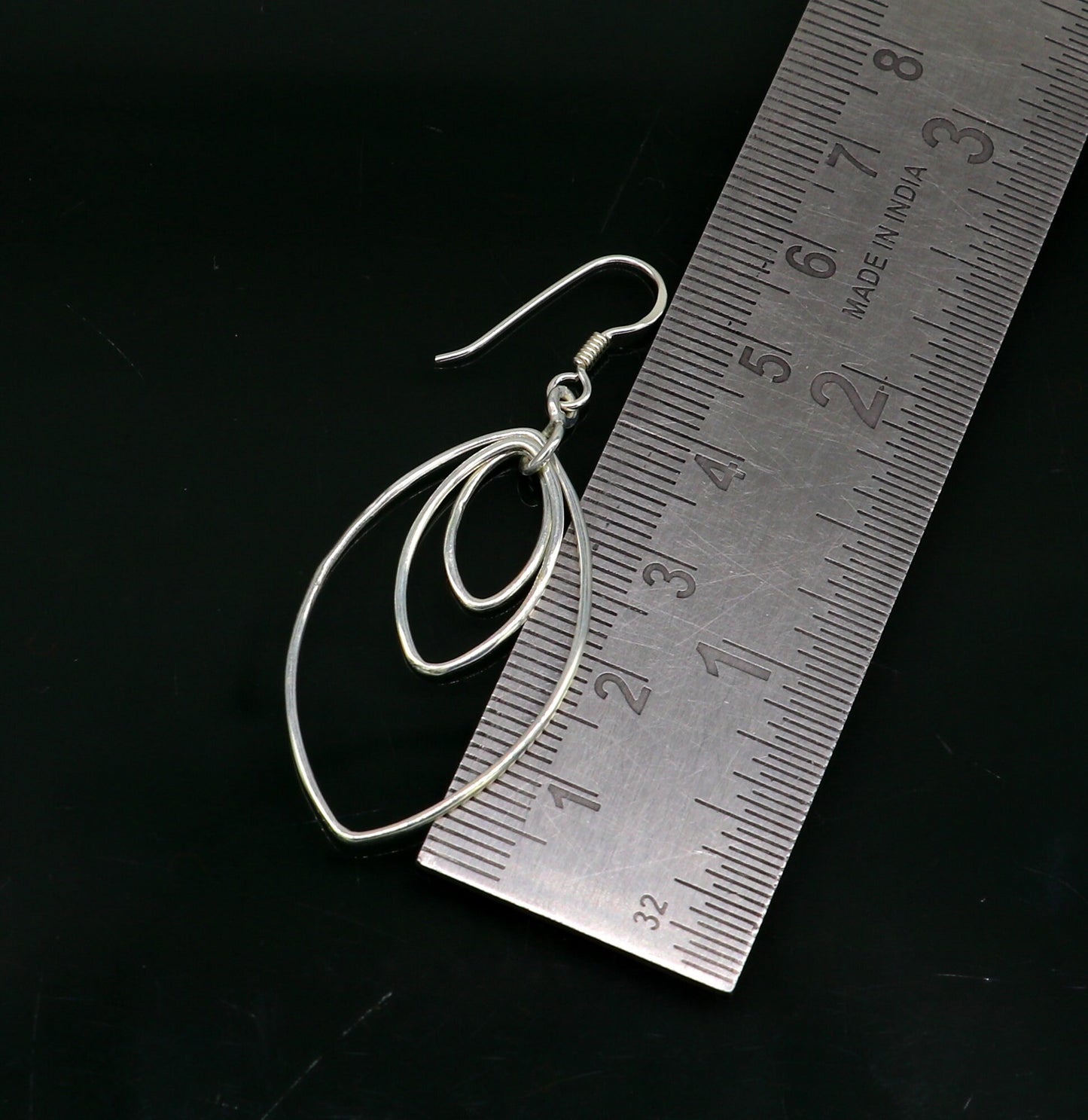 Sterling silver eclipse-style hoop earring with geometric drop dangle, handmade and trendy for elegant ear jewelry.