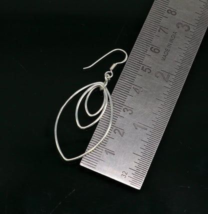 Sterling silver eclipse-style hoop earring with geometric drop dangle, handmade and trendy for elegant ear jewelry.