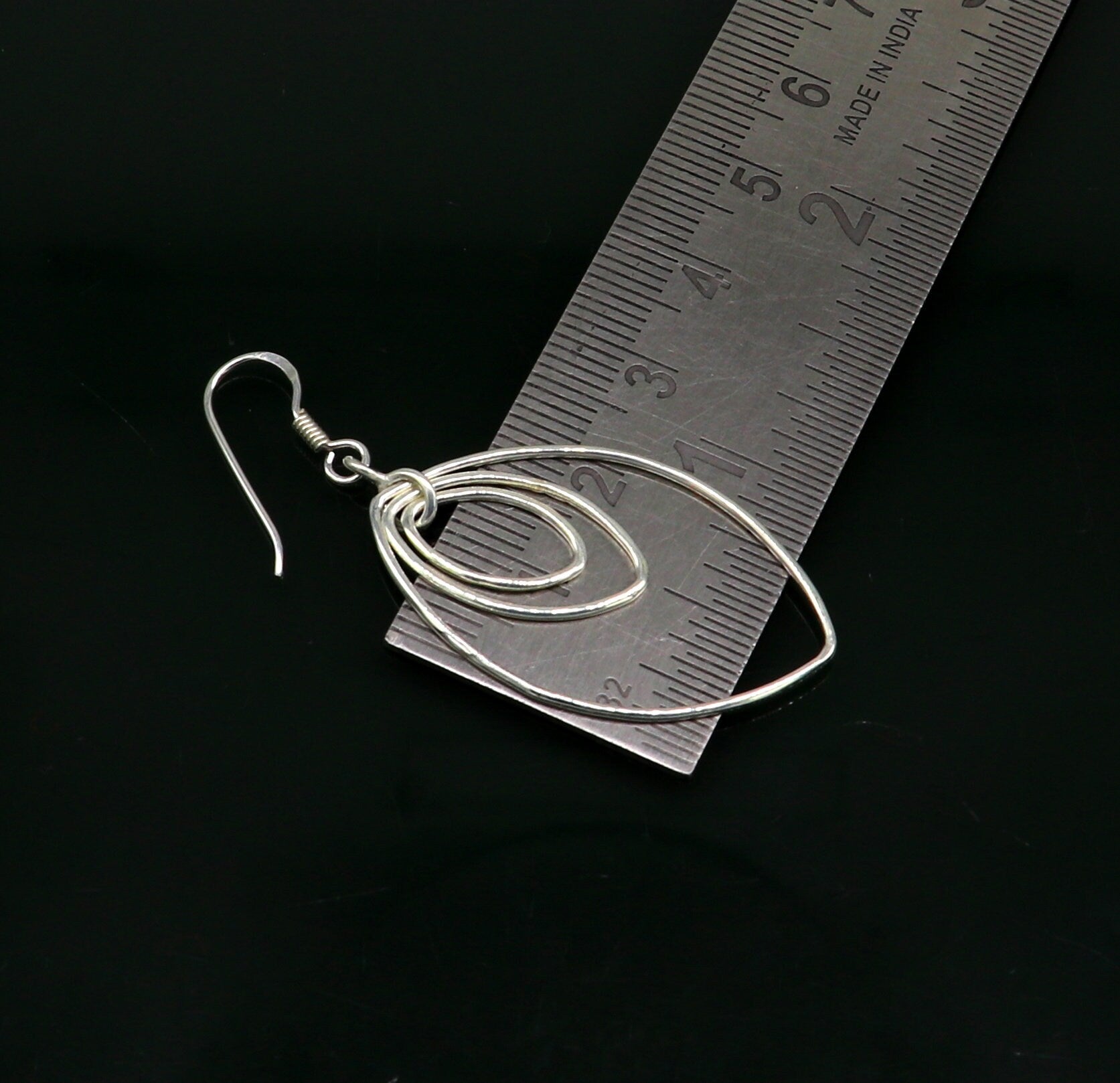 Sterling silver handmade eclipse style hoop earring with geometric drop design, elegant trendy jewelry by TRIBAL ORNAMENTS.