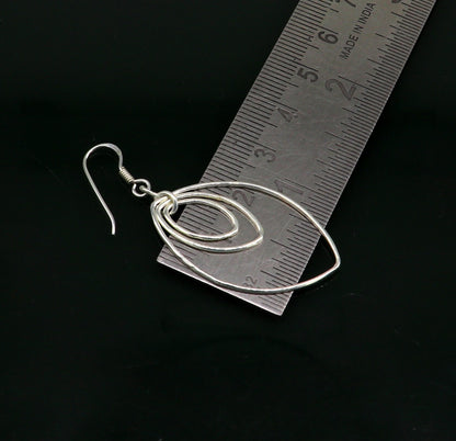 Sterling silver handmade eclipse style hoop earring with geometric drop design, elegant trendy jewelry by TRIBAL ORNAMENTS.