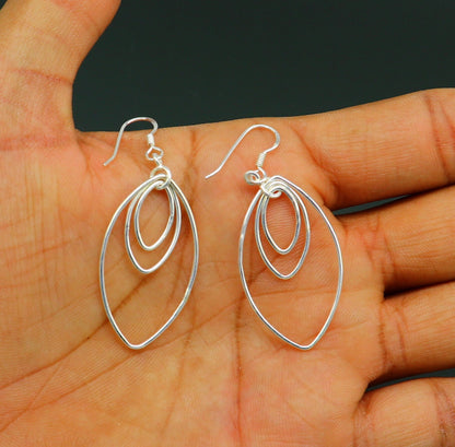 Sterling silver handmade eclipse-style hoop earrings with geometric drop dangle, elegant and trendy jewelry by TRIBAL ORNAMENTS
