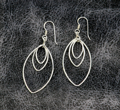 Sterling silver handmade eclipse-style hoop earring with geometric design, elegant and trendy drop dangle jewelry for women.