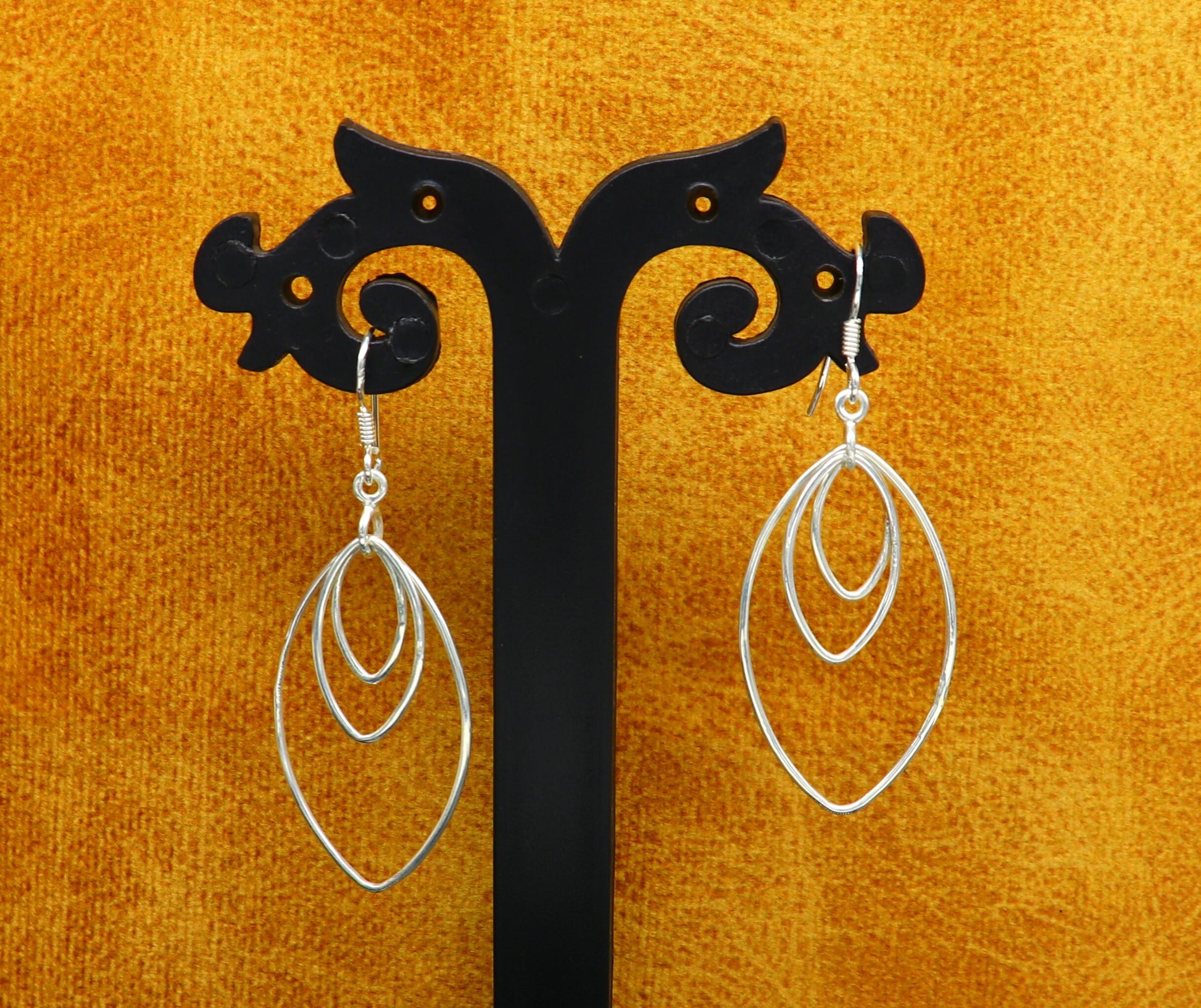 Elegant handmade sterling silver eclipse-style hoop earring with geometric drop design, perfect for her.