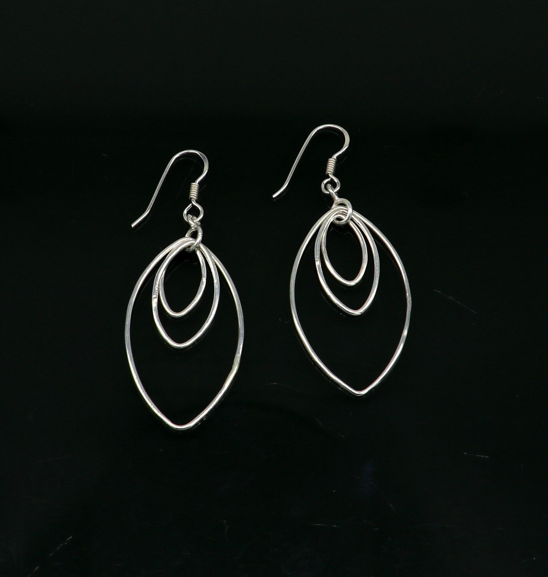 Sterling silver handmade eclipse style hoop earring with drop dangle geometric design by TRIBAL ORNAMENTS for elegant, trendy jewelry.