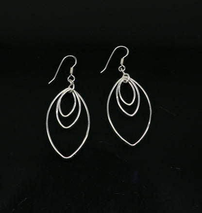 Sterling silver handmade eclipse style hoop earring with drop dangle geometric design by TRIBAL ORNAMENTS for elegant, trendy jewelry.